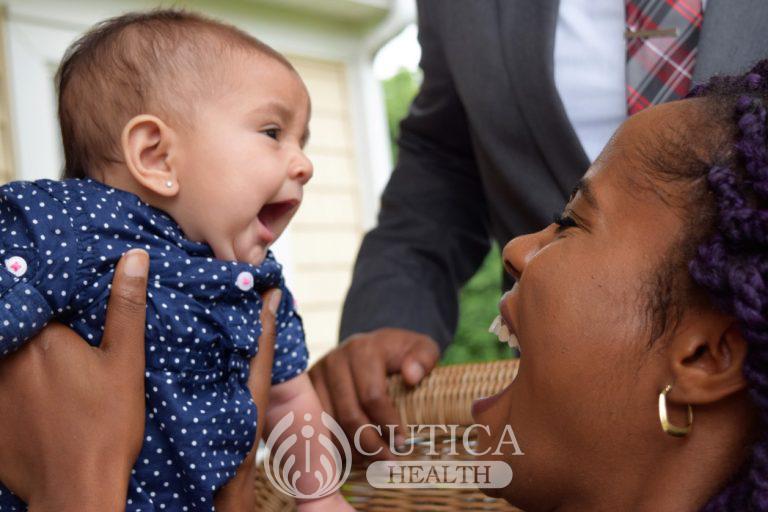 black-woman-lifting-up-and-smiling-and-laughing-with-baby-girl_t20_rK6wKw-768x512